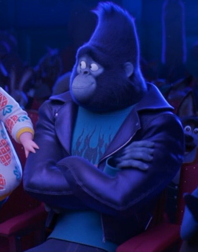 the gorilla and girl are standing next to each other in front of an audience with their arms crossed