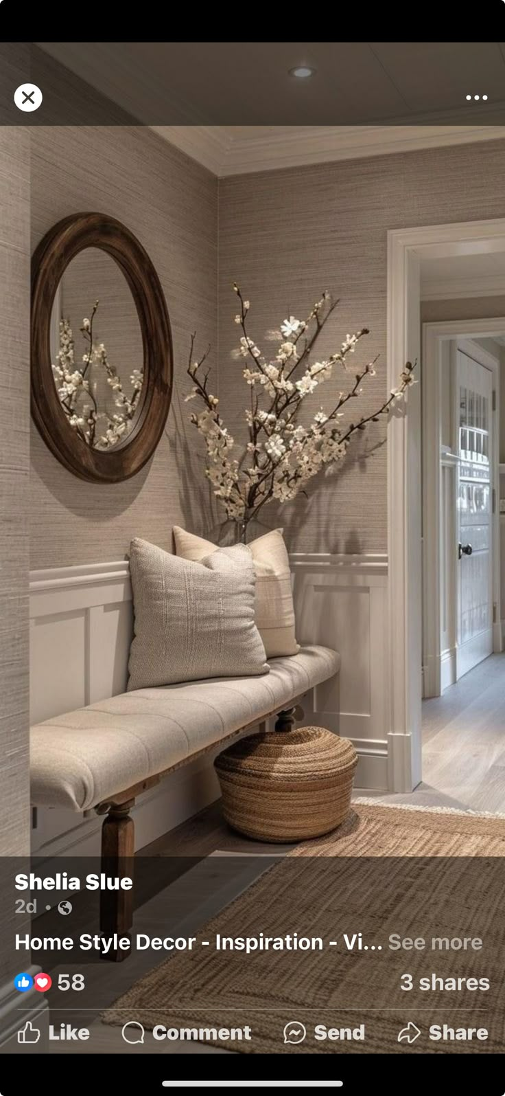 a living room with white furniture and flowers in the vase on the wall next to the couch