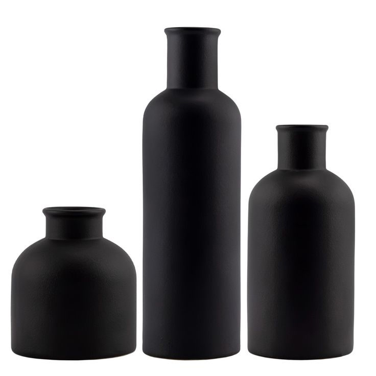 three black vases sitting next to each other