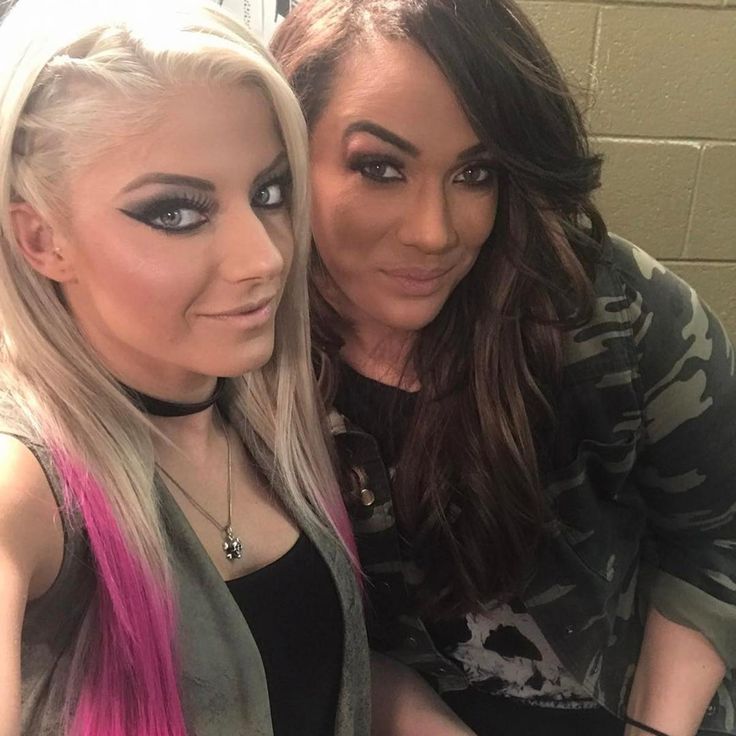 two women sitting next to each other in front of a mirror with their hair dyed pink