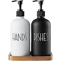 two black and white soap dispensers sitting on a wooden tray with the words dishes printed on them