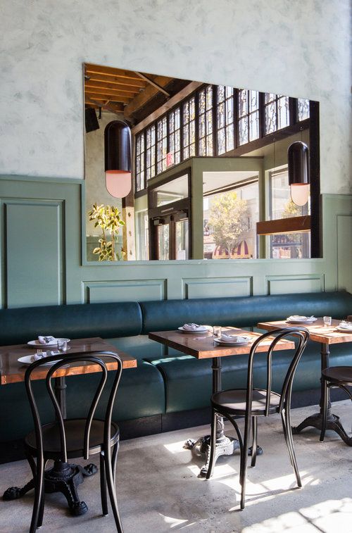 tables and chairs are lined up against the wall