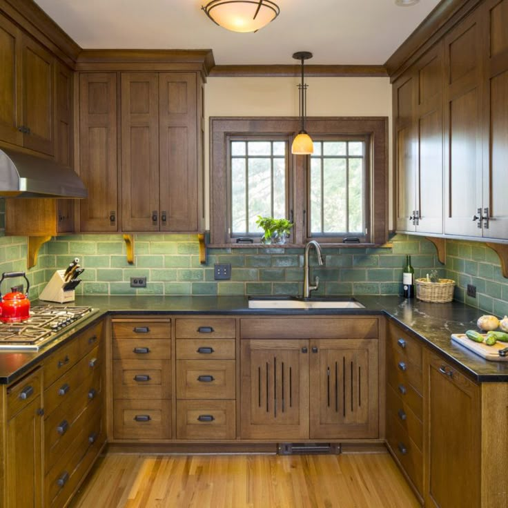 a kitchen with wooden cabinets and green tile backsplashing on the countertops