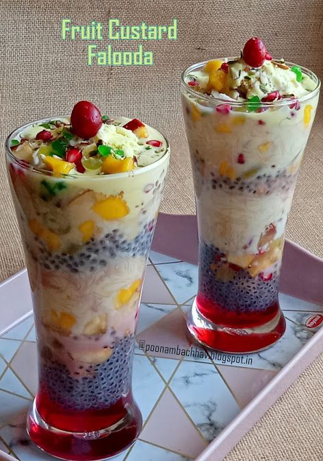 fruit custard falgoda is served in two tall glasses on a tray