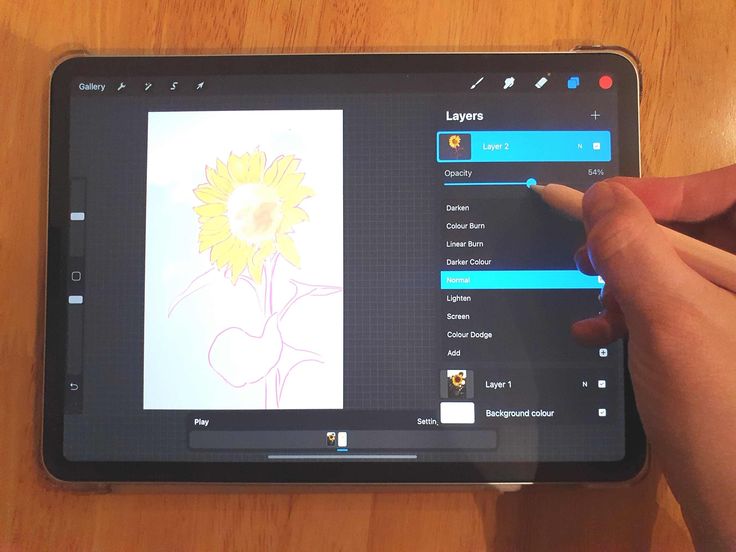 a person is drawing on an ipad screen