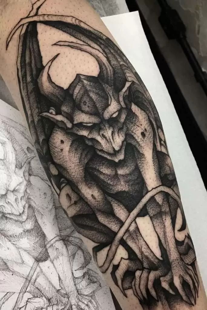 a man's arm with a dragon tattoo on it