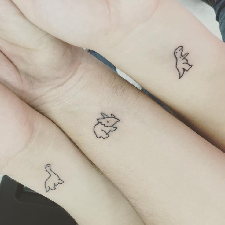 two people with matching tattoos on their arms