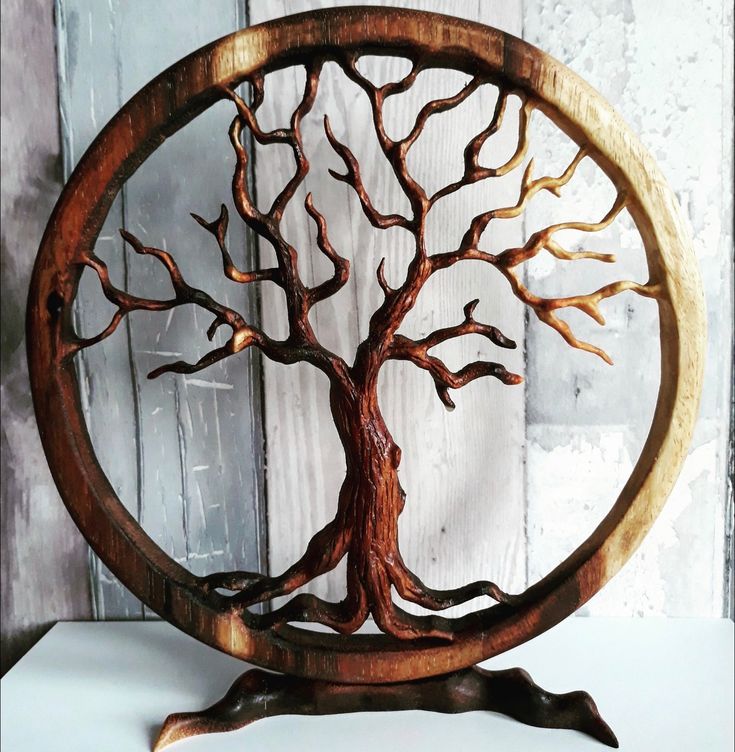 a wooden tree sculpture sitting on top of a table