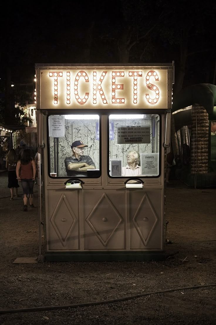 the ticket booth is lit up at night