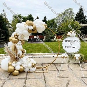 balloon arch with white, gold and silver balloons