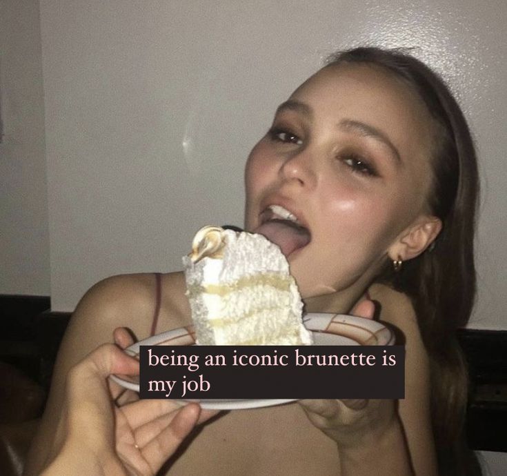 a woman eating a piece of cake with the caption being an iconic brunette is my job