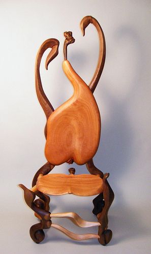 a sculpture of a bird sitting on top of a chair