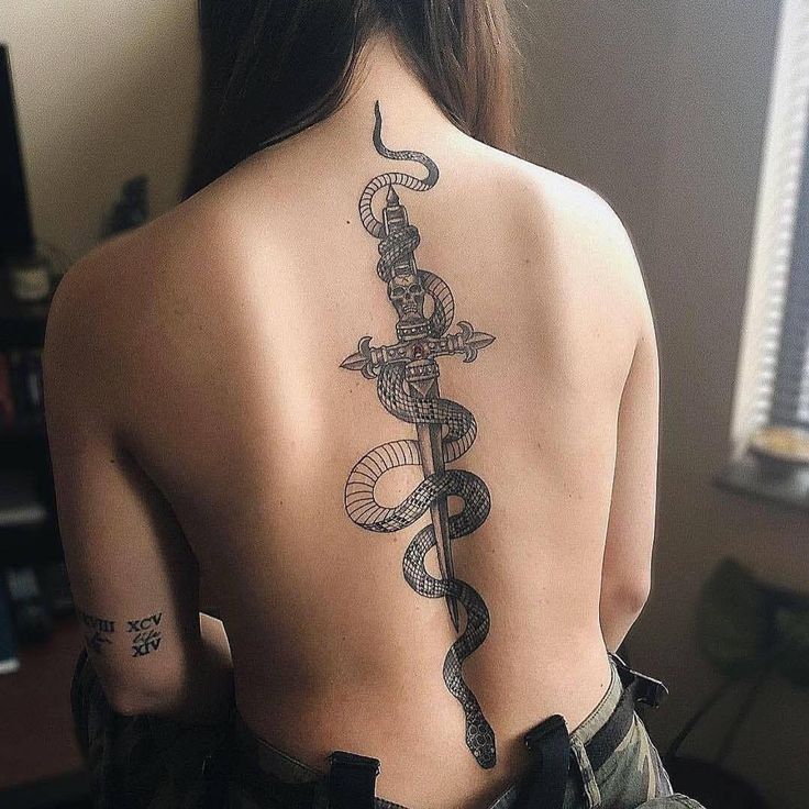 a woman with a snake tattoo on her back