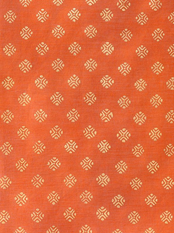 an orange and gold patterned fabric with white dots on the bottom, in rows of small squares