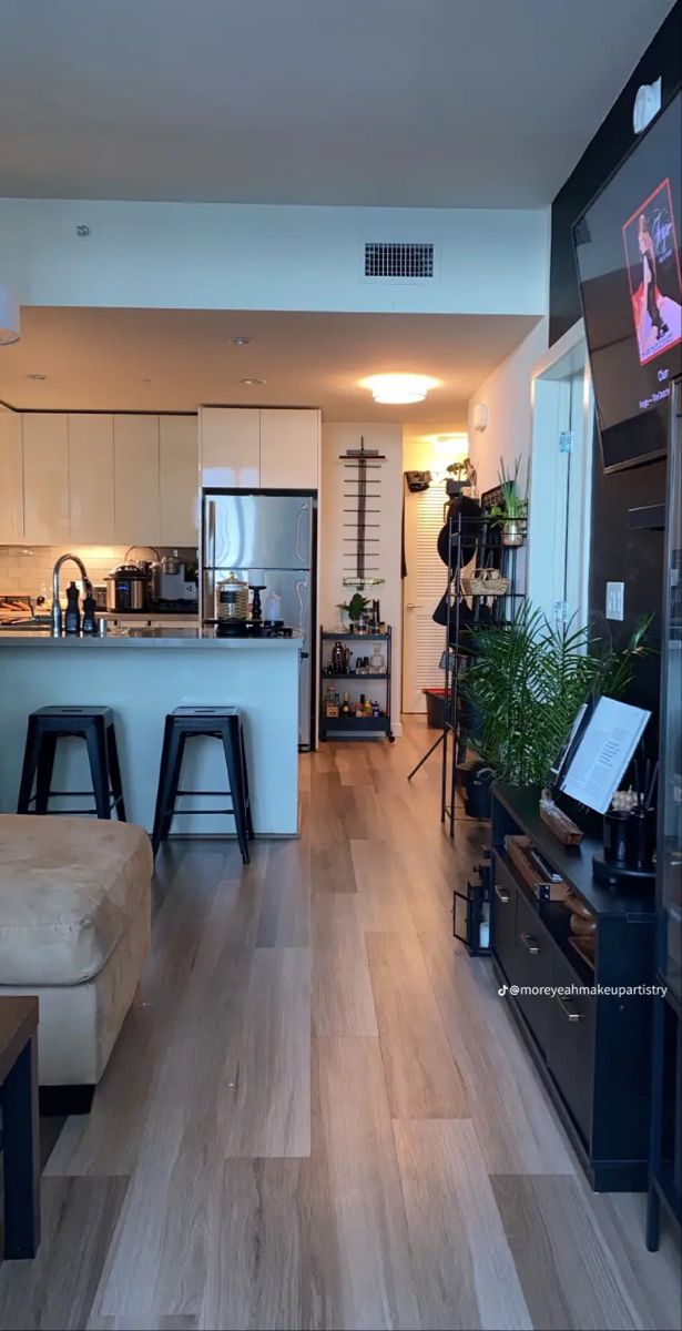 a living room filled with furniture and a flat screen tv mounted to the side of a wall