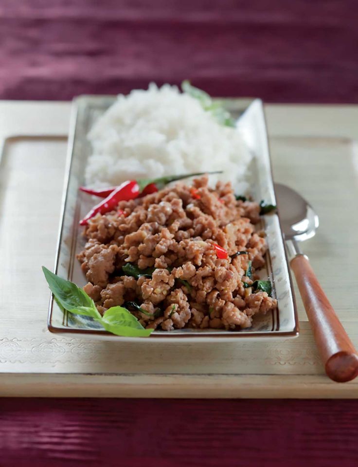 a plate with rice, meat and vegetables on it