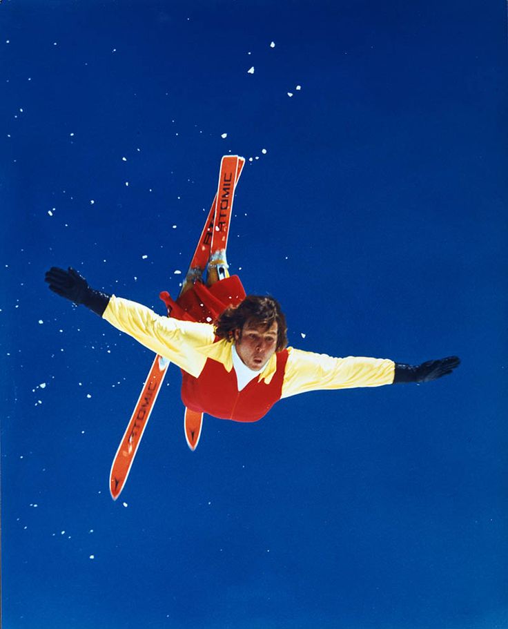 a man flying through the air while riding skis