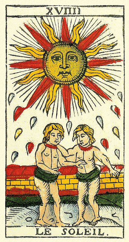 two men standing next to each other in front of a sun