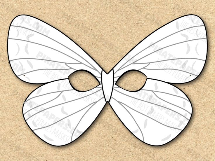 a white butterfly mask cut out on a piece of cardboard with the shape of an eye