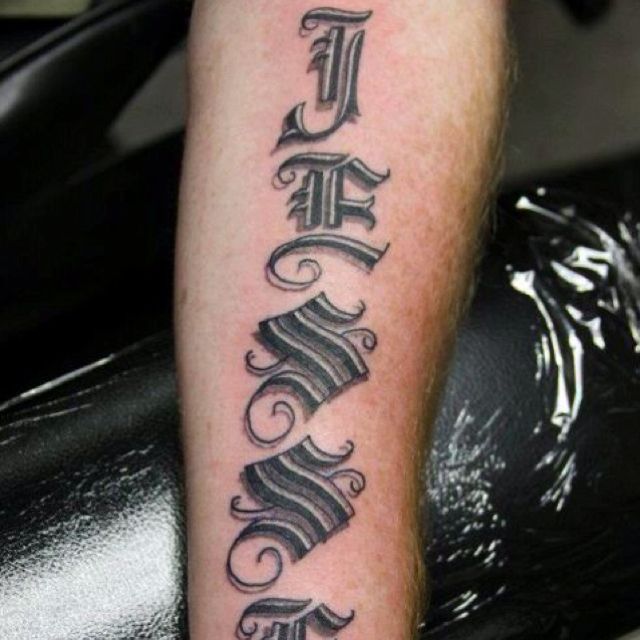 a man with a tattoo on his leg that says faith and has the word faith written in cursive font