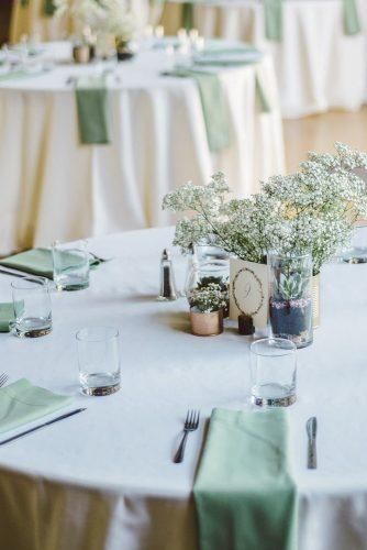 the table is set with flowers and place settings