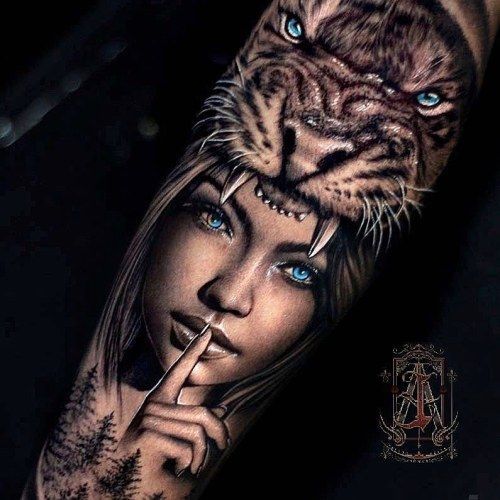 a woman with blue eyes and a tiger on her arm