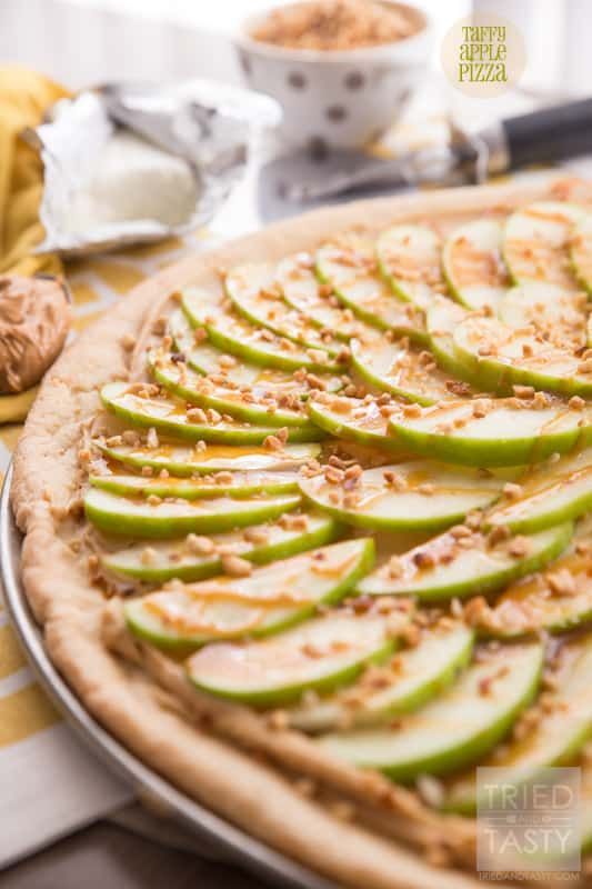 an apple and walnut tart with nuts on the side, ready to be eaten