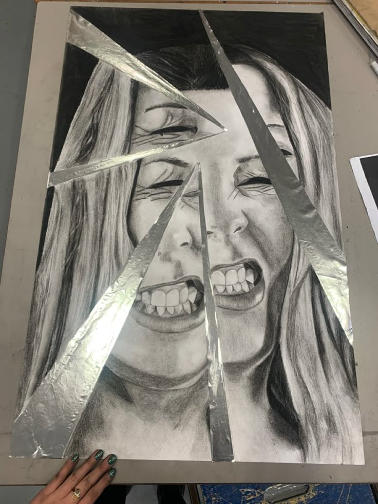 a drawing of a woman's face is being cut into pieces with large scissors