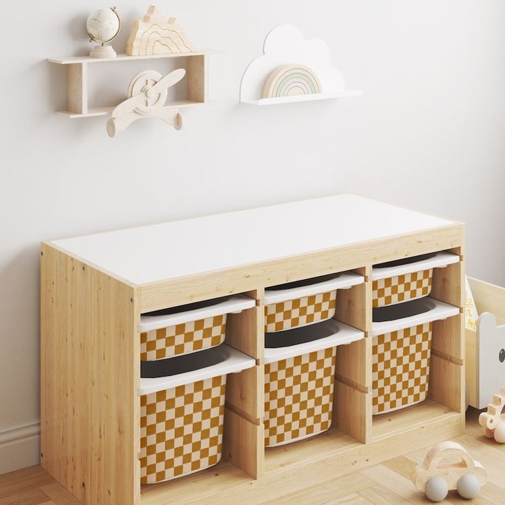 a wooden shelf with baskets and toys on it in a child's playroom