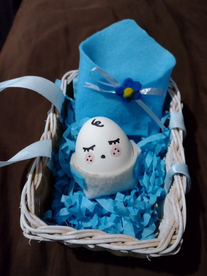 an egg in a basket with blue tissue