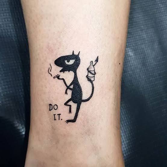 a small tattoo on the foot of a person with a lizard and words do it