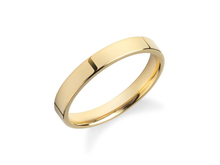 a yellow gold wedding ring on a white background