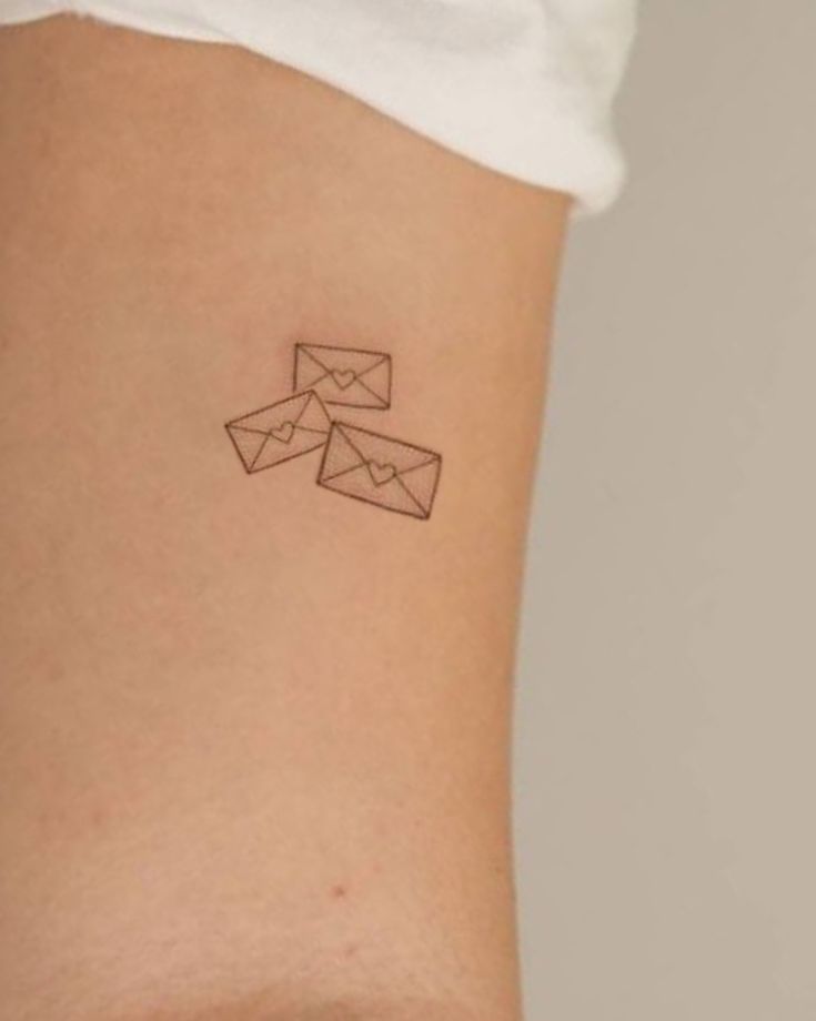 a woman's stomach with an origami tattoo on it