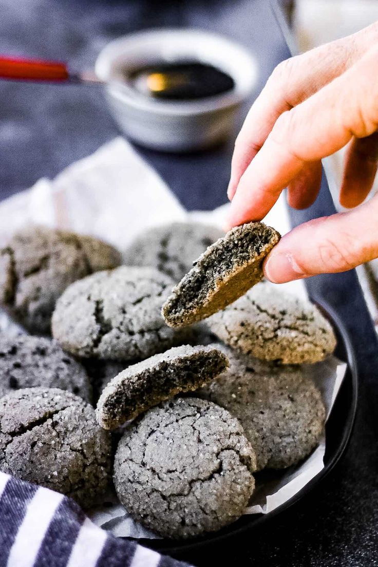 a person picking up some cookies from a plate