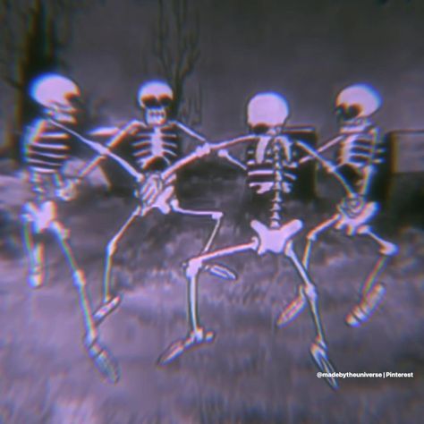 three skeletons are dancing in the grass