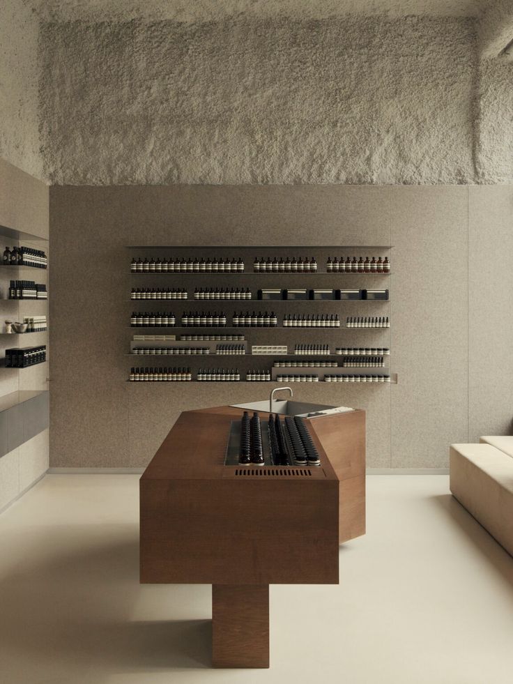 an empty room with several shelves on the wall and two tables in front of them