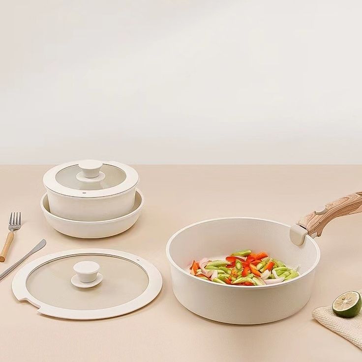 a table topped with white dishes and utensils