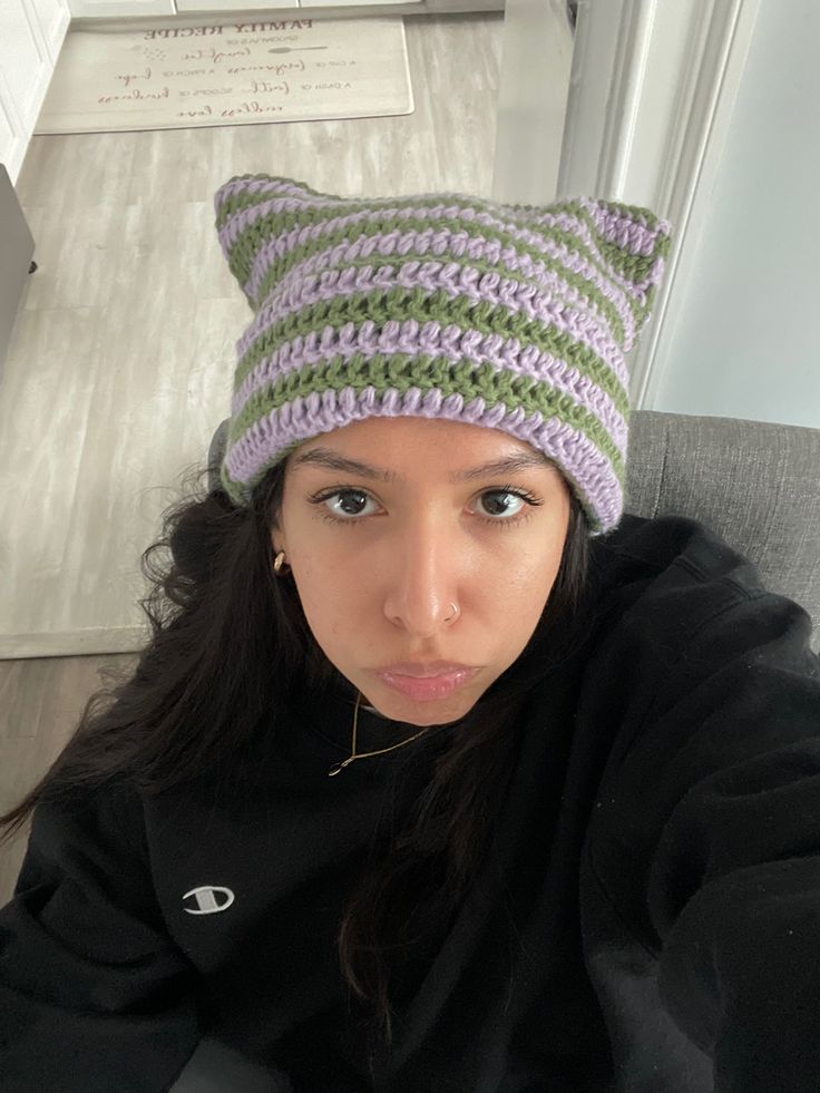 a young woman wearing a knitted cat hat