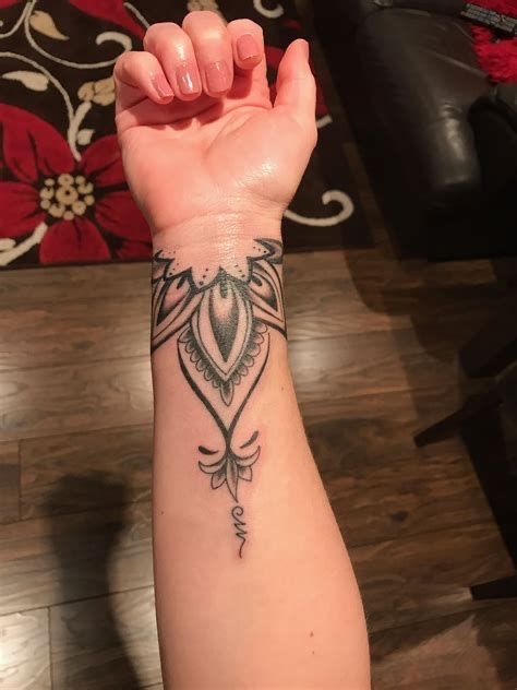 a woman's arm with a tattoo on it and an arrow in the middle