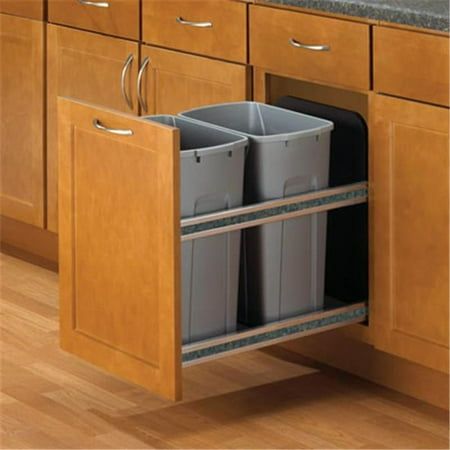 two trash cans are in the pull out bins on the kitchen cabinet door drawers