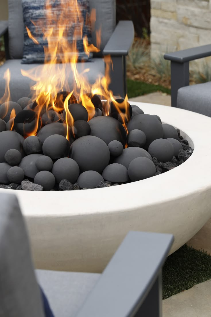 an outdoor fire pit with rocks in it