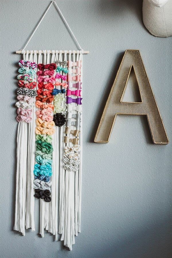 a wall hanging made out of yarn with the letter a on it's side