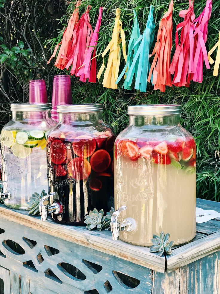 several jars filled with liquid sitting on top of a table