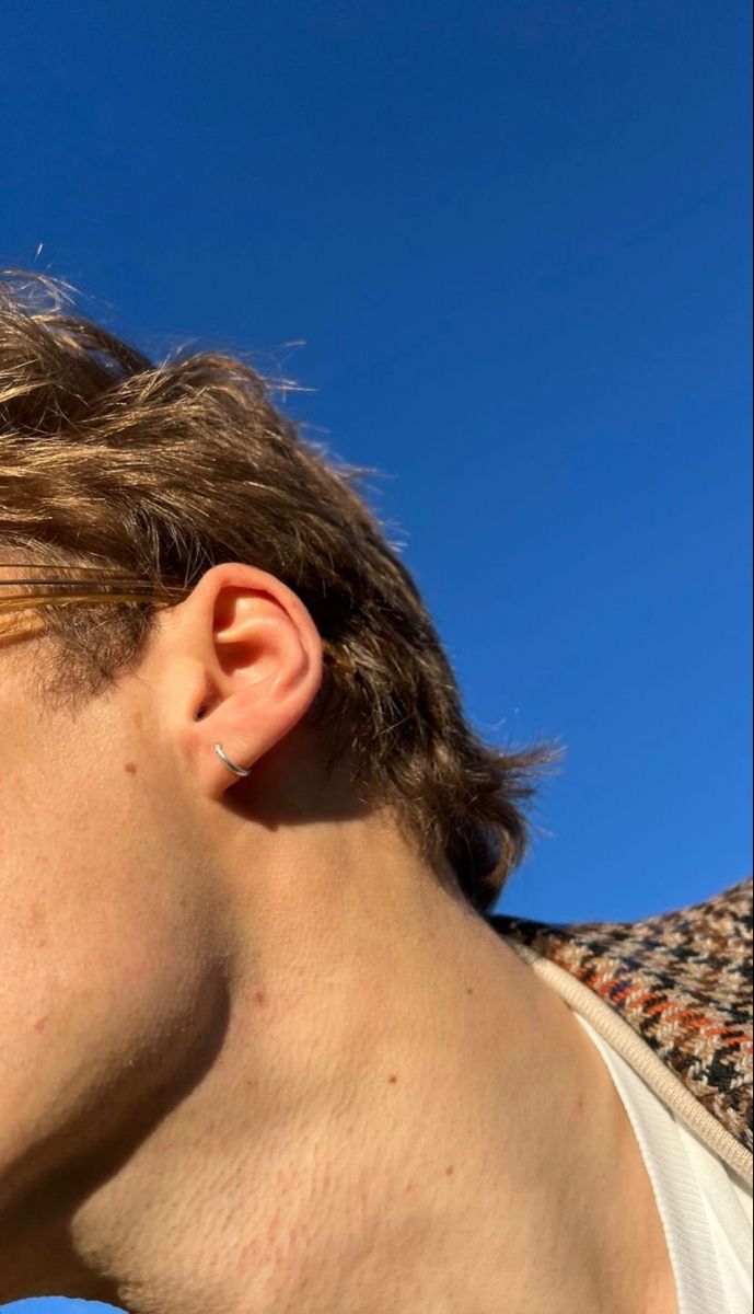 a close up of a person with ear piercings