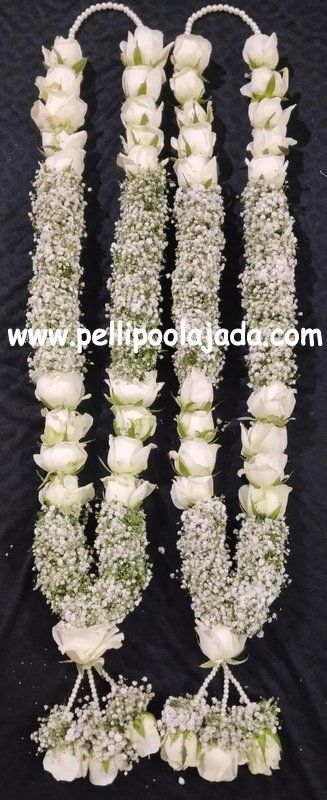 white flowers and baby's breath are arranged in the shape of letters