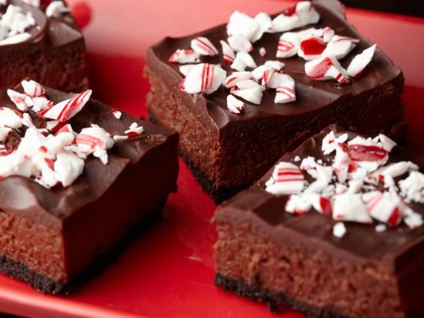 three pieces of chocolate cake with candy canes on top