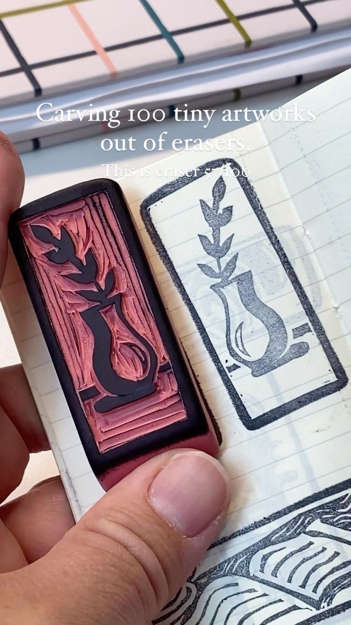 a hand holding a rubber stamp that is in front of a book with stamps on it