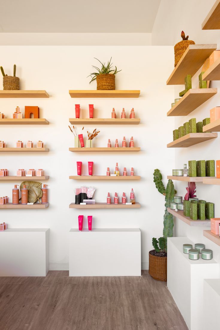 the inside of a store with shelves filled with different types of products and candles on them