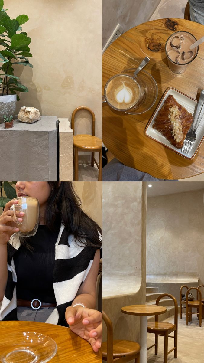 a woman sitting at a table drinking from a cup