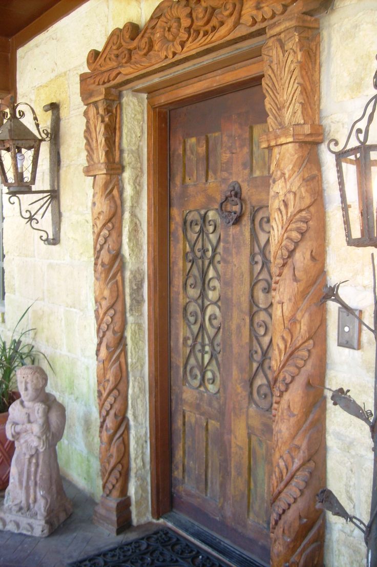 an ornate wooden door with decorative iron work